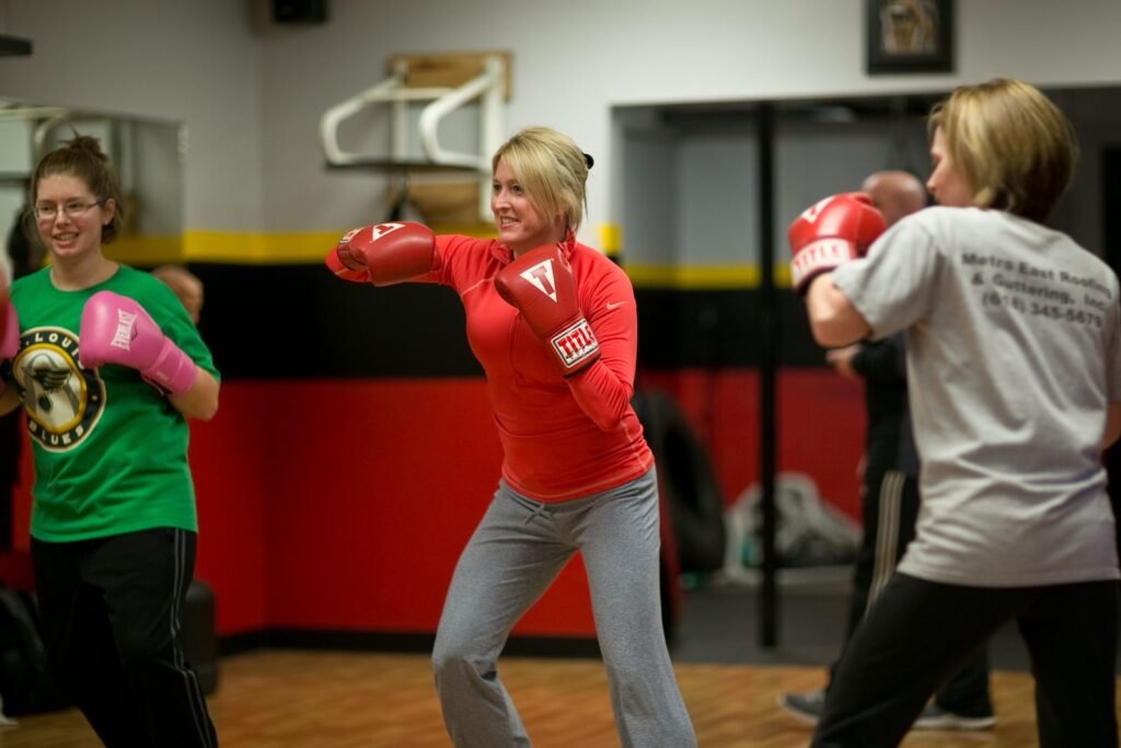 Group fitness class with boxing gloves at Troy American Fitness