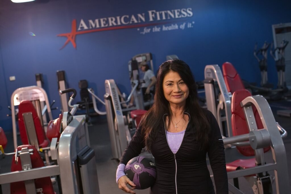 Member with a medicine ball on the strength floor at Troy American Fitness